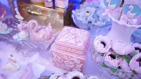 Sweets table with pink swan and decorative ballerina at birthday party Stock Footage 266073046