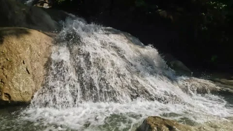 The swift flow of a low waterfall in the mountains Stock Footage 321860461
