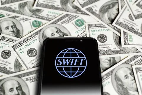 SWIFT logo on smartphone screen on background of dollars. Moscow, Russia - Stock Photos