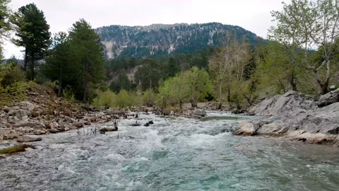 A swift mountain river, flying a drone over the water 4k Video stock 213979489