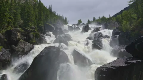Swift mountain waterfall. Forest and mountains, drone video. Stock Footage 245135389