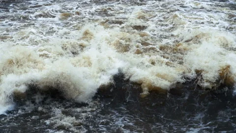 Swift turbulent flow of water with splashes and foam in spectacular slow motion. Stock Footage 109324610