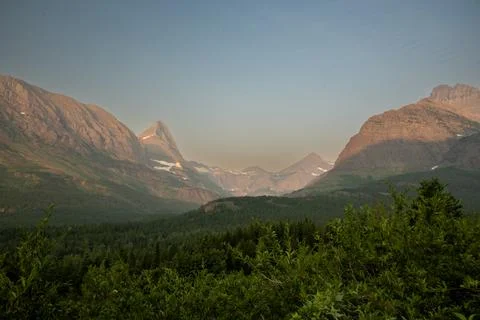 Swiftcurrent Mountain Rises In The Distant Background Over Mount Grinnell A.. 库存照片