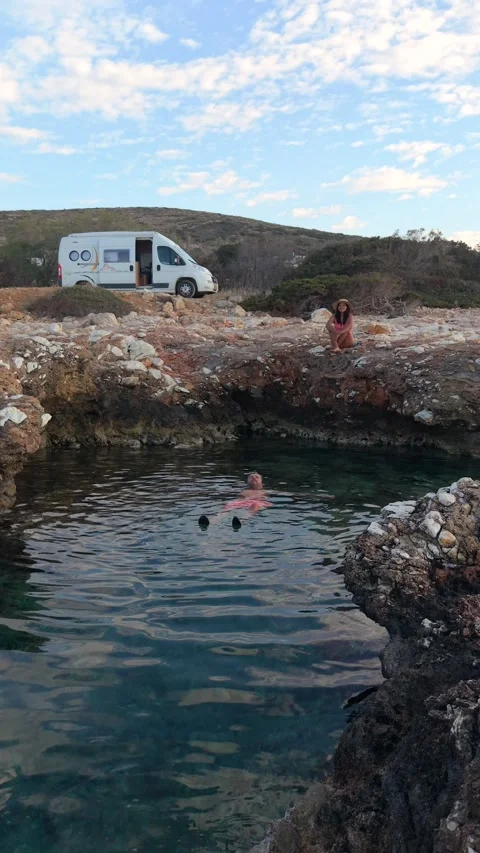 Swim in the crystal-clear waters of Paros Island, Greece within stunning rocky Stock Footage 337373526