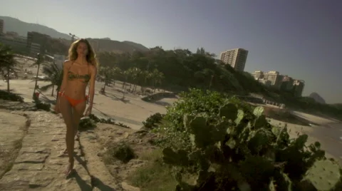 Swim suit model approaches camera in slow motion Vídeos de archivo 44058591