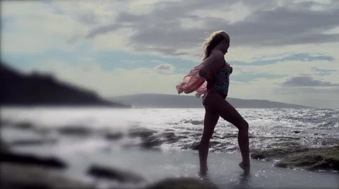 Swim suit model in sillowette posing on windy Maui beach 動画素材 43794802