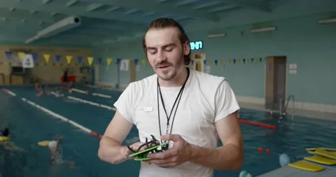 Swim trainer showing how to use paddles Stock Footage 169465664
