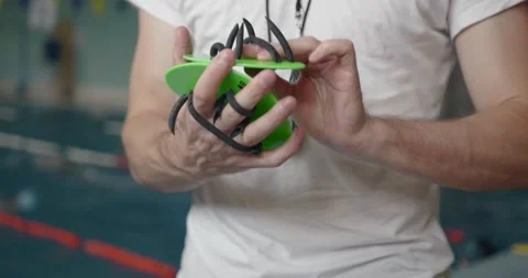 Swim trainer showing how to use paddles Stock Footage 169465827