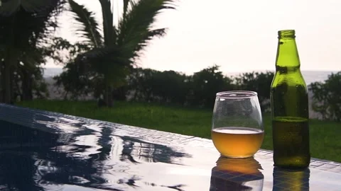 Swiming pool, beer and sunset at the beach Stock Footage 130809157