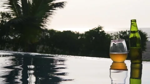 Swiming pool, beer and sunset at the beach Stock Footage 130809859