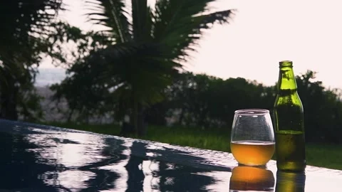 Swiming pool, beer and sunset at the beach Stock Footage 130809866