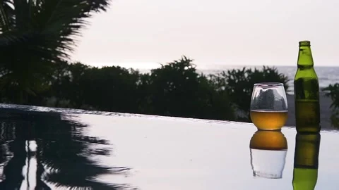 Swiming pool, beer and sunset at the beach Stock Footage 130809898