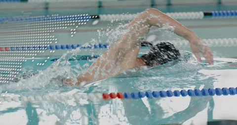 Swimmer appearing as pulsing code overlay reveals ripples, doing freestyle laps Stock Footage 331712890