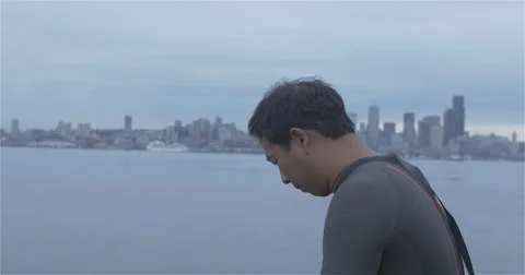 Swimmer applying cap with Seattle background Stock Footage 40274159