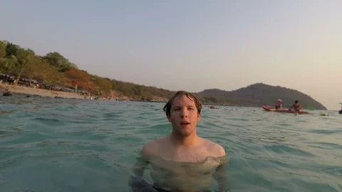 Swimmer Casually Floating in Warm Ocean And Diving Underwater Stock Footage 127916620