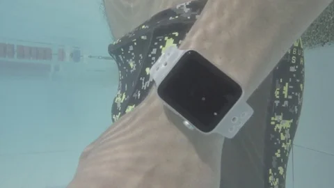 Swimmer checks watch 스톡 동영상 77053906
