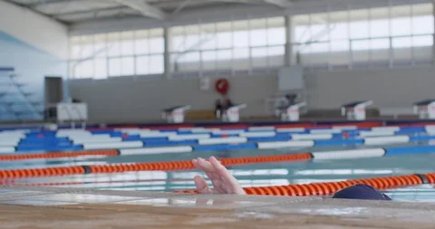 Swimmer coming out of water and looking at camera 库存影片 124591353