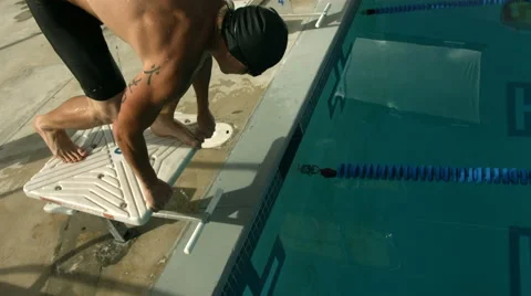 Swimmer dives from starting block, super slow motion Stock Footage 62284151
