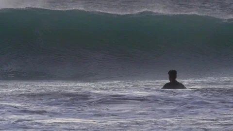 Swimmer ducks under wave in slow motion Stock Footage 86846723
