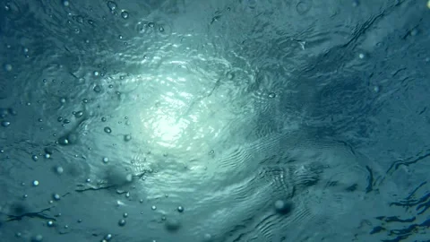 Swimmer enjoys refreshing dive in crystal-clear tropical pool Stock Footage 337166358