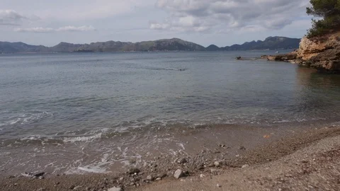 Swimmer filmed by a drone flying by while training in a lake Stock Footage 118838191