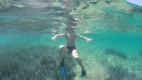 Swimmer in flippers dives into the sea Stock Footage