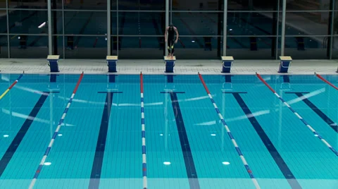 Swimmer jumping from starting block and butterfly swimming Stock Footage 30458705