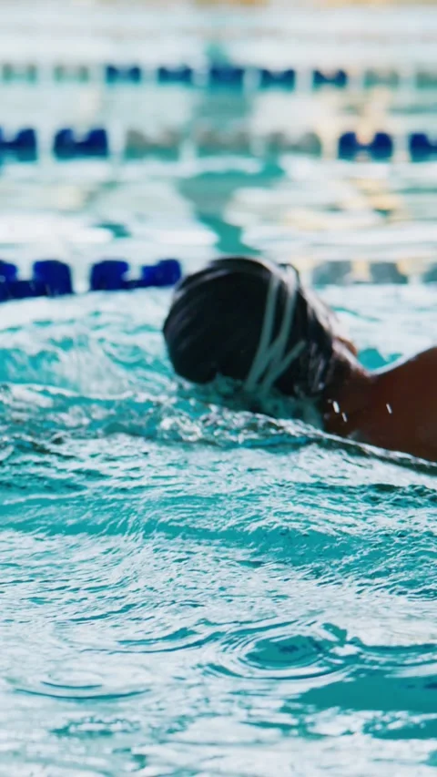 Swimmer moves dynamically through pool with strong arm motion Stock Footage 346458077