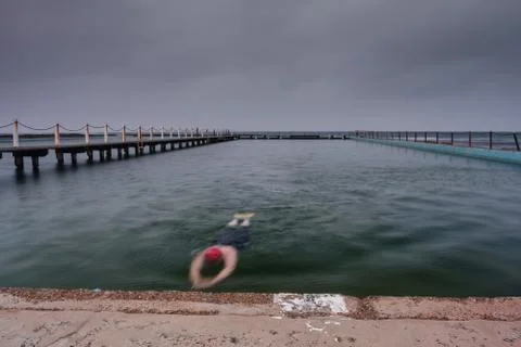 Swimmer in an ocean pool Stock Photos