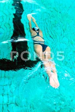 Swimmer into pool Stock Photos