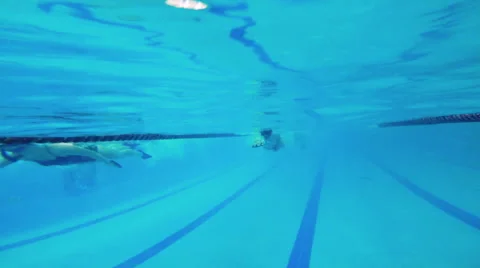 Swimmer pushes away from the pool side and swimming in the opposite direction Stock Footage 60187707