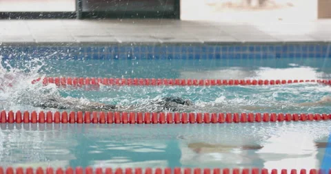 Swimmer pushing off wall, crawling across lane activating graphic overlays Stock Footage 315076607