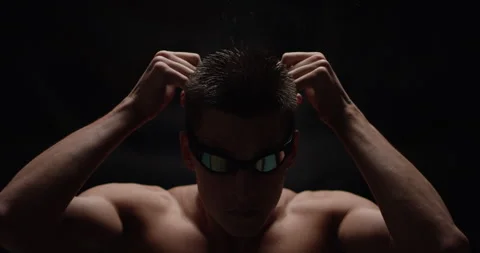 Swimmer putting his goggles on Stock Footage 283040295