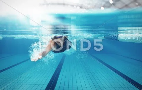 Swimmer racing in pool Stock Photos