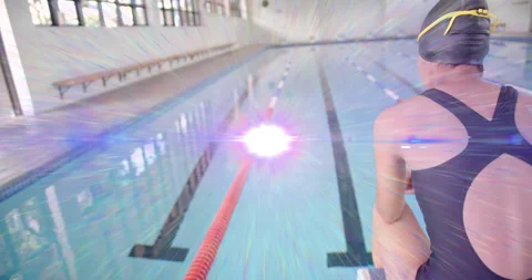 Swimmer sitting poolside watching glow spawning tech orb gliding along lanes and Video stock 315092946