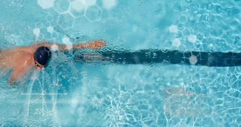 Swimmer stroking under overhead camera with lane marker and tech overlay Stock Footage 315549640