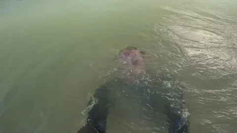 Swimmer Submerged by Breaking Ocean Wave at Mirissa Beach, Sri Lanka Stock Footage 340856859