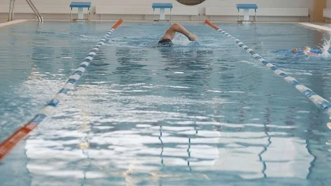 Swimmer swims on an empty track with a swimming cap Stock Footage 125573136