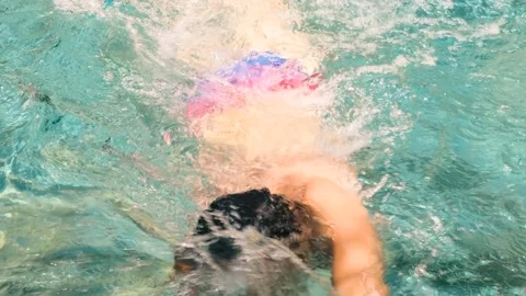 Swimmer trains in pool. Young athletic man wearing swimming goggles 스톡 동영상 178813301