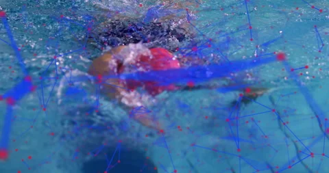 Swimmer wearing red cap dipping waist in pool initiating freestyle stroke for Stock Footage 315550587