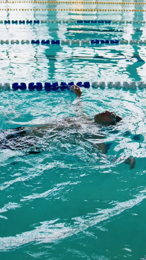 Swimmer's body cuts through water with steady, powerful strokes Stock Footage 346458008