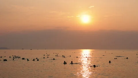 Swimmers enjoying the ocean at sunset Stock Footage 336566879