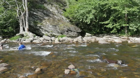 Swimmers Float Down Mountain Stream Video stock 51399702