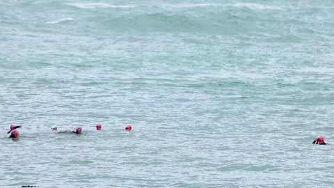 Swimmers Navigating Ocean Waves at Port Campbell 動画素材 307379586