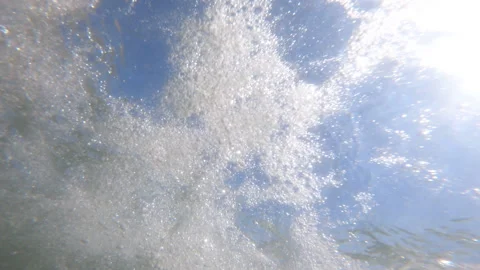 Swimmers POV of diving headfirst through ocean waves Video stock 137206304