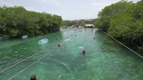 Swimming and taking a zip line ride at Xel-Ha, Cancun Stock Footage 50233280