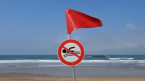 Swimming forbidden sign with red flag. Beach in Biarritz, France. Stock Footage 99708960