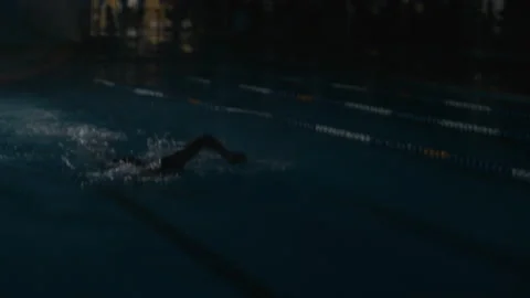 Swimming freestyle in the pool at night Stock Footage 169237485