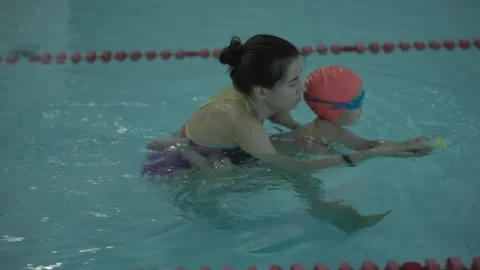 Swimming Lesson Child Engaged with Instructor in Pool for Training and Skill Stock-Footage 314709322