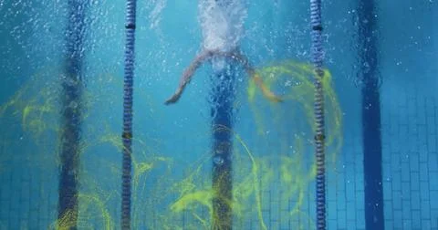 Swimming man in trunks moving down lane in lap pool with lane ropes, bubbles, Stock Photos